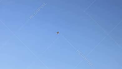 The F16 fighter performs aerobatics over the sea against the background of mountains