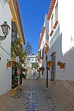 Narrow cobbled colourful back street in Estepona Spain