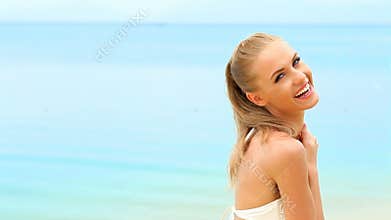 Woman in white bikini relaxing on the beach