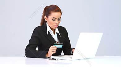 Beautiful business woman using credit card