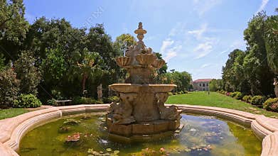 footage of a water fountain with lush green trees and flowers at Huntington Library and Botanical Gardens in San Marino California