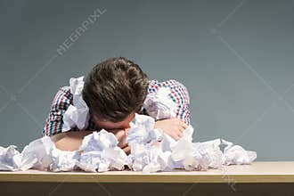 Author lying in the heap of paper