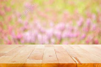 Wood table top on blur flower garden background