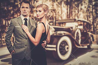 Couple against vintage car