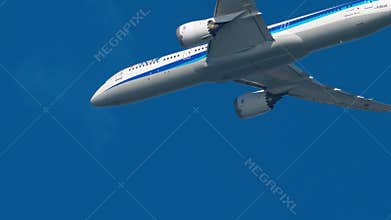 ANA All Nippon Airways Boeing 787 Dreamliner flying in blue sky