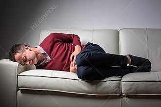 Young man suffering from severe belly pain