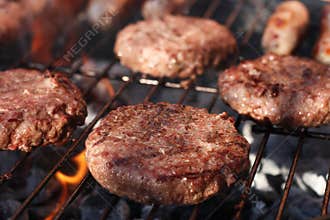 Food meat - burgers on barbecue grill.
