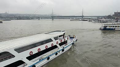 Istanbul, Turkiye - March 30, 2026: Passenger ferry turns toward pier near Galata Bridge while crossing Golden Horn waterway