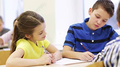 Group of students talking and writing at school