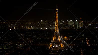Sparkling Eiffel tower in Paris seen at night from an aerial view