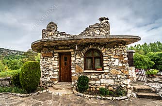 BULGARIA: Fairy-tale stone cottage with stone roof in village garden