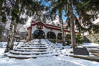 BULGARIA: Exterior of stone Orthodox church in winter snow landscape