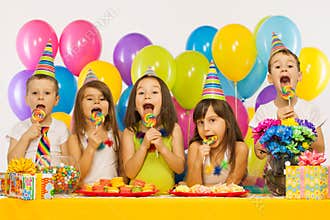 Group of joyful little kids having fun at birthday