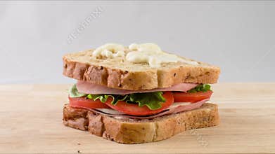 Making sandwich with tomato, salad, ham, stop motion