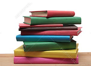 Books on wooden shelf close-up isolated white