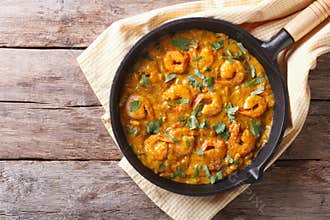 Shrimp in curry sauce in the pan. horizontal top view