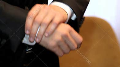 Hands of handsome man in black suit