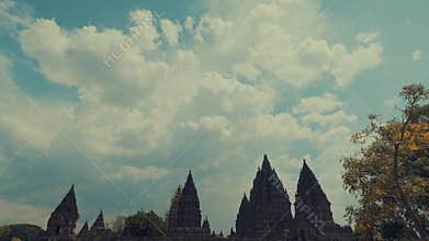 Majestic Hindu Temple Spires Beneath Fluffy Clouds and Blue Sky
