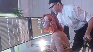 Programmers working at night analyzing code on monitors in a modern office