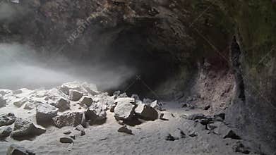 Dust Streaming Down Hole Of Lava Tube Cave