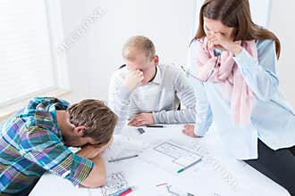 Tired architects working on a project