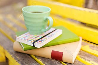 Books and cup on wooden table