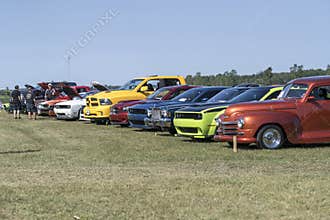 Brightly colored cars parked in row during outdoor exhibition