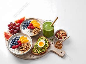 Nourishing breakfast arrangement features yogurt bowls with berries granola avocado toast with egg a vibrant smoothie