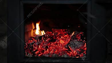 Man putting Log Woods inside a Fireplace