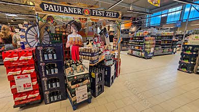 UBERLINGEN, GERMANY - SEPTEMBER 30, 2026: Promotional retail zone showcasing stacks of Bud, Spaten, and Hacker Pschorr