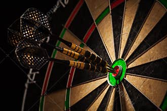 Three darts in bull's eye close up