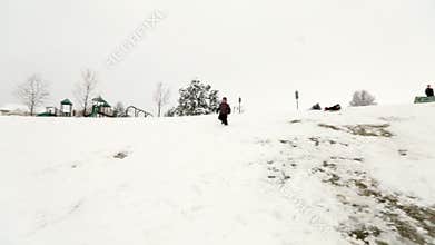 Boy running down snow hill