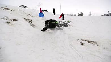 Boy sledding off jump