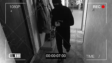 Surveillance camera caught the robber in a mask with a crowbar
