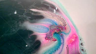 Bright multi-colored handmade bath bomb dissolves