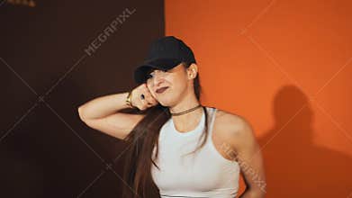 Female hip-hop dancer. Beautiful dancer posing in a studio.