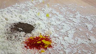 Turmeric is added to mix peppers and flour. Slow motion