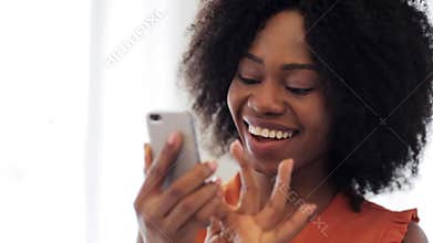 Happy african american woman with smartphone