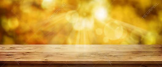 Golden autumn background with table