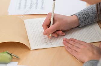 Student writing Chinese characters