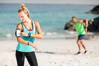 Woman using smartphone on armband