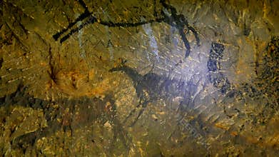 Discovery of prehistoric paint of caveman hunt in sandstone cave. Paint of human hunting of deers, mammoth and reindeer. Spotlight