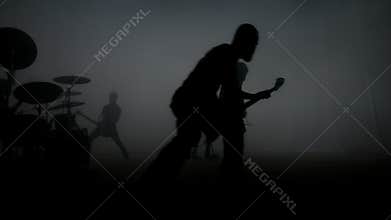 Rock music concert. Silhouettes of rock group on concert stage