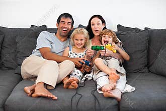 Family on Sofa Playing Video games