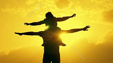 Father and son playing in the evening sky silhouette