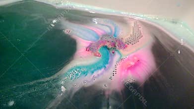 Bright multi-colored handmade bath bomb dissolves
