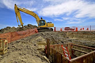Road construction site with excavating machine
