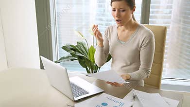 Young businesswoman receiving notice of dismissal, letter with bad news