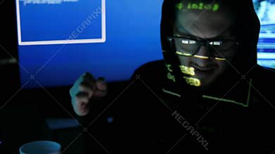 Evil, criminal hacker portrait, nervous hacker cracking system, internet espionage, hacked access password, computer