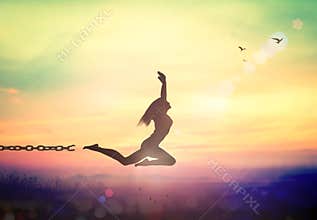 Freedom Concept Woman Breaking Chain and Jumping at Sunrise